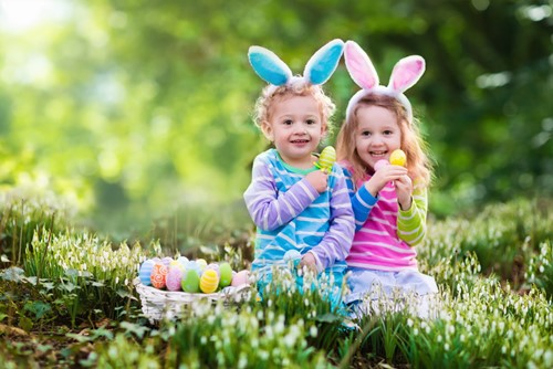 Two young children on an Easter Egg hunt.