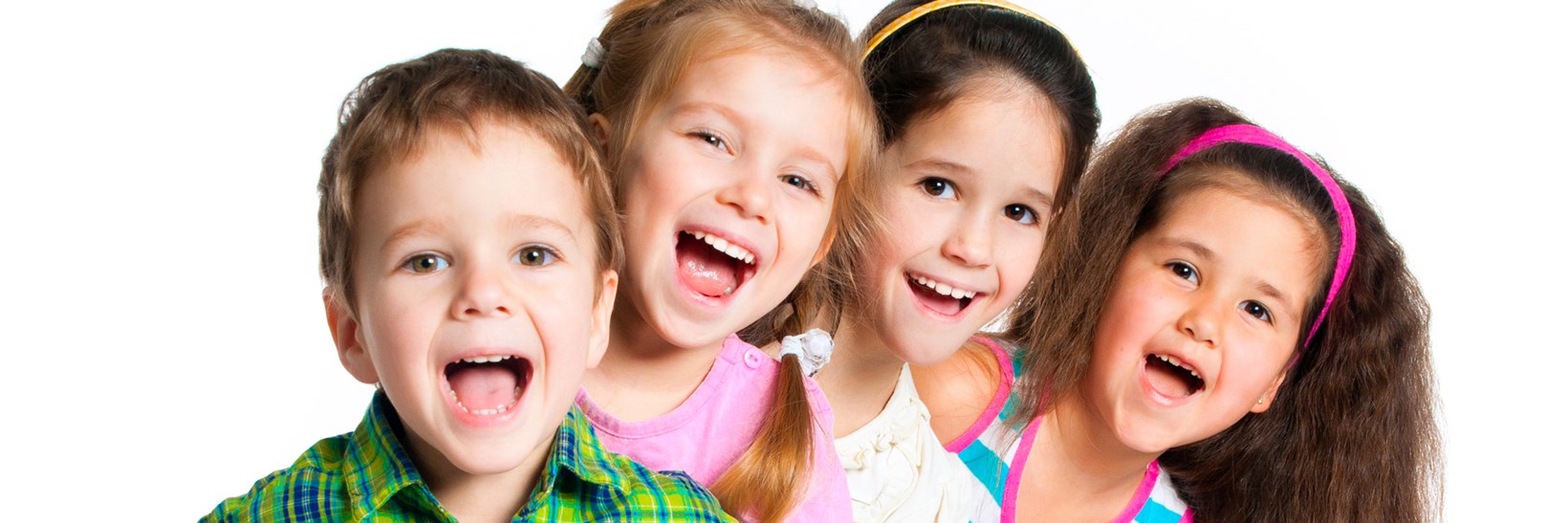 Four primary school children smiling
